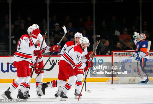 Jean-Francois Berube of the New York Islanders reacts as Jaccob Slavin of the Carolina Hurricanes is congratulated by his teammates after scoring a...