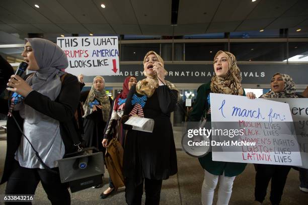 Women demonstrate in support of a ruling by a federal judge in Seattle that grants a nationwide temporary restraining order against the presidential...