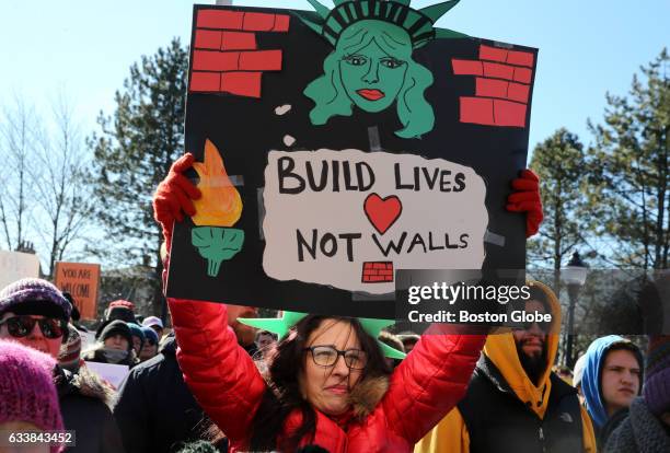 Bambi Best of Somerville holds a sign during a rally in support of the communitys 30 years as a sanctuary city at Somerville High School in...