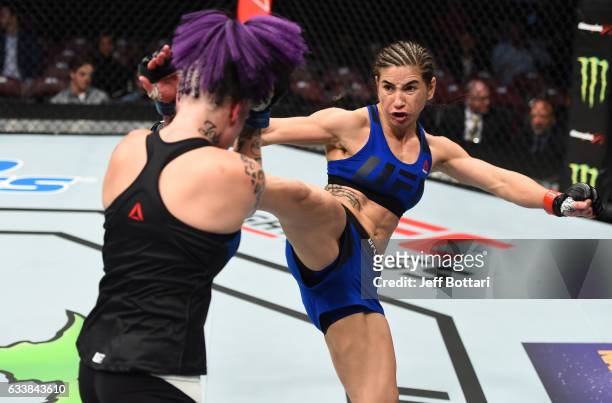 Tecia Torres kicks Bec Rawlings of Australia in their women's strawweight bout during the UFC Fight Night event at the Toyota Center on February 4,...