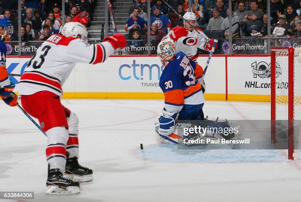 Jean-Francois Berube of the New York Islanders reacts as Jeff Skinner celebrates a second period goal by Lee Stempniak of the Carolina Hurricanes at...