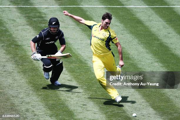 Pat Cummins of Australia kicks the ball towards the stumps in an attempt to run out a dashing Neil Broom of New Zealand during game three of the One...