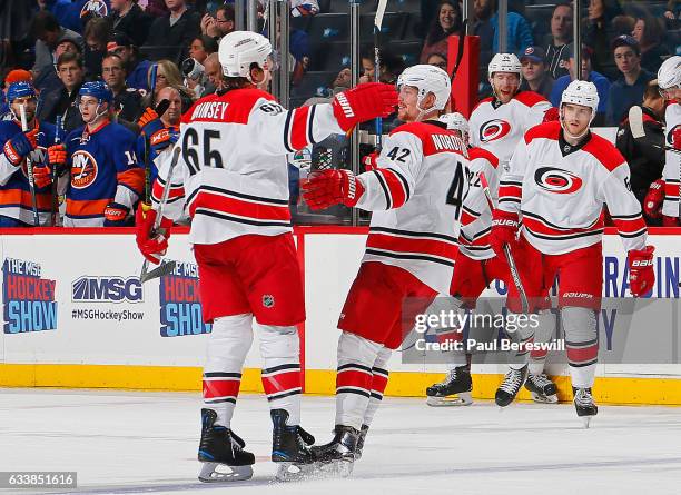 Ron Hainsey of the Carolina Hurricanes is congratulated by his teammate Joakim Nordstrom after scoring the game winning goal in overtime against the...