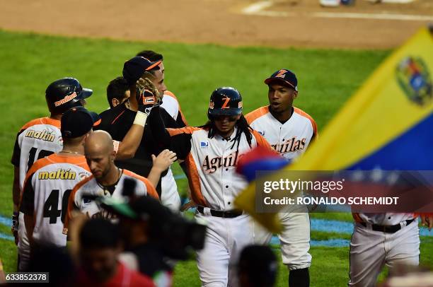 Players of Aguilas del Zulia from Venezuela celebrate after scoring against Alazanes de Granma from Cuba during their Caribbean Baseball Series at...