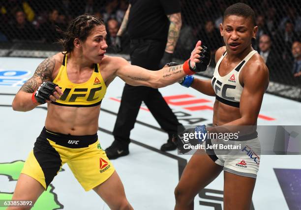 Jessica Andrade of Brazil punches Angela Hill in their women's strawweight bout during the UFC Fight Night event at the Toyota Center on February 4,...