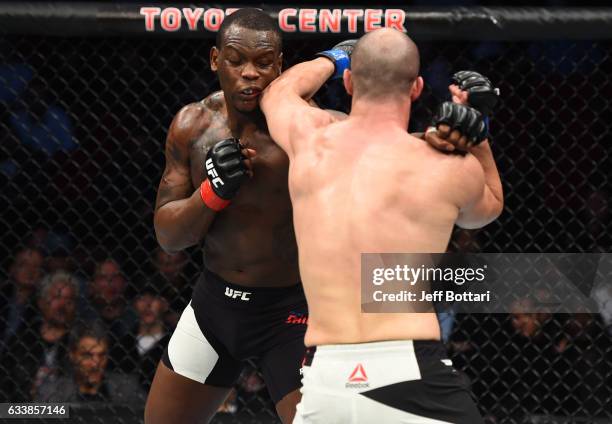 Volkan Oezdemir of Switzerland punches Ovince Saint Preux in their light heavyweight bout during the UFC Fight Night event at the Toyota Center on...