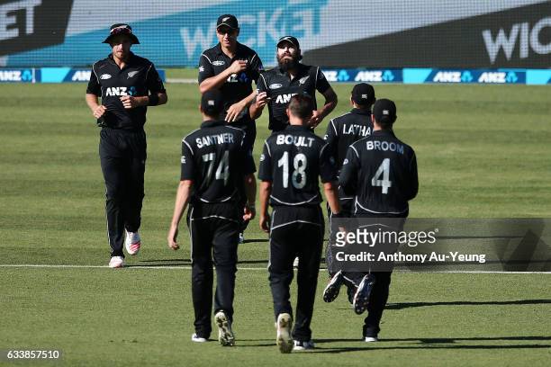 Dean Brownlie of New Zealand celebrates with teammates for the wicket of Travis Head of Australia during game three of the One Day International...