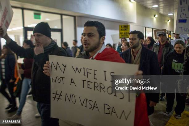 Demonstrators march in support of a ruling by a federal judge in Seattle that grants a nationwide temporary restraining order against the...