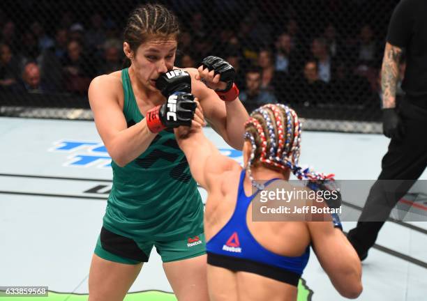 Felice Herrig punches Alexa Grasso of Mexico in their women's strawweight bout during the UFC Fight Night event at the Toyota Center on February 4,...