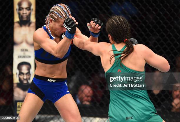 Alexa Grasso of Mexico punches Felice Herrig in their women's strawweight bout during the UFC Fight Night event at the Toyota Center on February 4,...