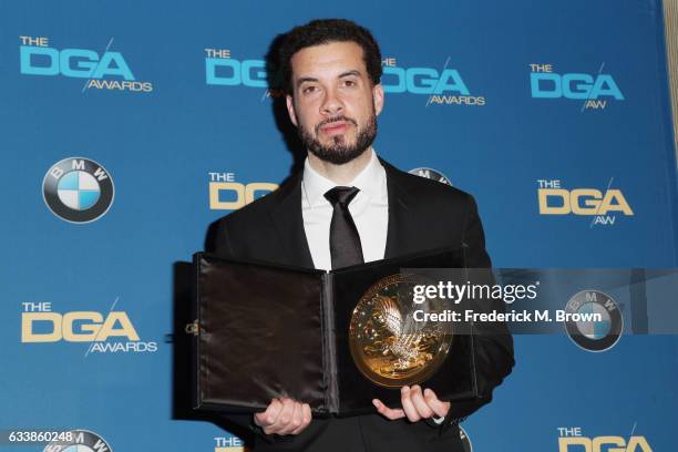 Director Ezra Edelman, winner of the Outstanding Directorial Achievement in Documentary for 'O.J.: Made in America,' poses in the press room during...