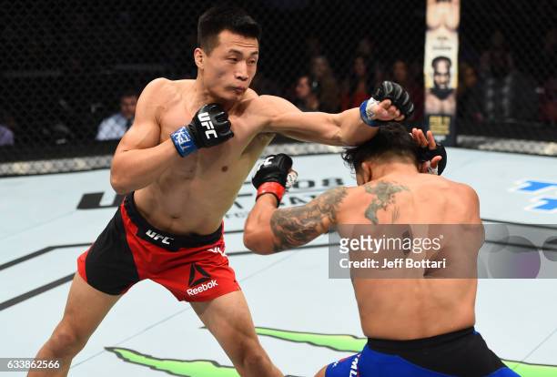 Chan Sung Jung of South Korea punches Dennis Bermudez in their featherweight bout during the UFC Fight Night event at the Toyota Center on February...