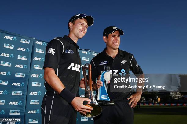 Trent Boult and Ross Taylor of New Zealand celebrate with the Chappell-Hadlee Trophy and ANZ Series Trophy after winning game three of the One Day...