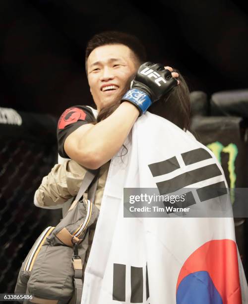 Chan Sung Jung of South Korea celebrates with family after defeating Dennis Bermudez of their featherweight bout during the UFC Fight Night event at...