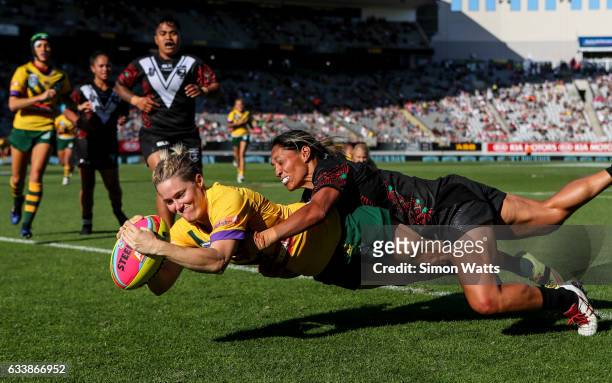 Chelsea Baker of the Jillaroos scores a try as Sarina Fiso of the Kiwi Ferns tackles during the 2017 Auckland Nines match between the Australian...