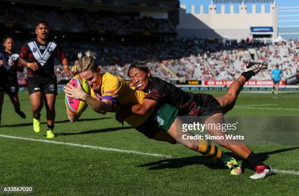 Chelsea Baker of the Jillaroos scores a try as Sarina Fiso of the Kiwi Ferns tackles during the 2017 Auckland Nines match between the Australian...