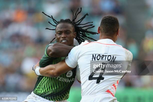 Seabelo Senatla of South Africa is tackled by Dan Norton of England during the Cup Final match between England and South Africa in the 2017 HSBC...