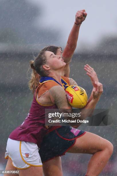 Tayla Harris of the Lions marks the ball against Katherine Smith of the Demons during the round one Women's AFL match between the Melbourne Demons...