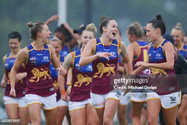 Kate McCarthy of the Lions and Emily Bates celebrate the win during the round one Women's AFL match between the Melbourne Demons and the Brisbane...