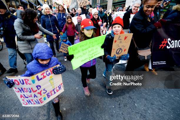 Children of various ages are seen participating in peaceful and family friendly protest during the February 4th, 2017 March for Humanity, in Center...