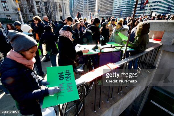 Protestors prepare signs at a mobile sign making station on a transport tricycle as an estimated 5.000 protest the Donald Trump Presidency during the...