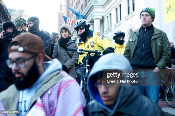 Protestors look on as during the March for Humanity a group of Muslims stop for prayer outside Independence Hall, in Philadelphia, PA, on February...