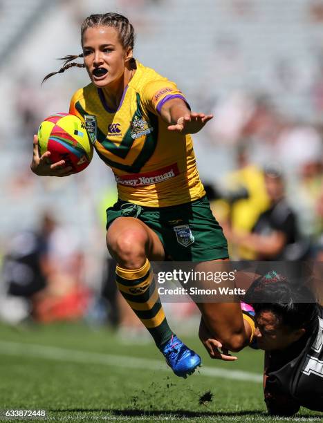 Isabelle Kelly of the Jillaroos looks to beat the tackle of Alexandra Cook of the Kiwi Ferns during the 2017 Auckland Nines match between the...