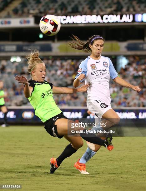 Hannah Brewer of Canberra clears as she is challenged by Erika Tymrak of Melbourne City during the W-League Semi Final match between Canberra United...