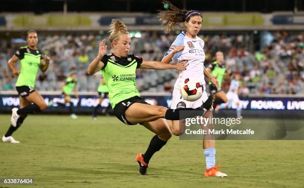 Hannah Brewer of Canberra clears as she is challenged by Erika Tymrak of Melbourne City during the W-League Semi Final match between Canberra United...