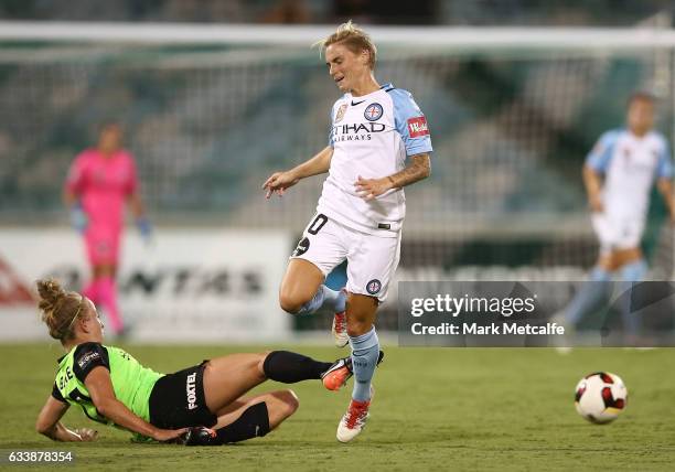 Jessica Fishlock of Melbourne City is tackled by Hannah Brewer of Canberra during the W-League Semi Final match between Canberra United and Melbourne...