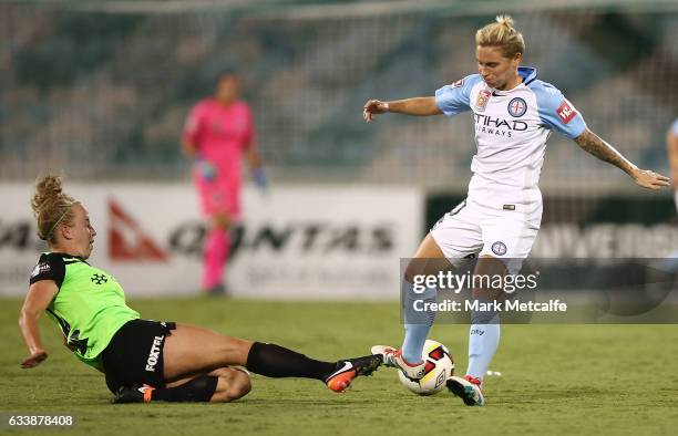 Jessica Fishlock of Melbourne City is tackled by Hannah Brewer of Canberra during the W-League Semi Final match between Canberra United and Melbourne...