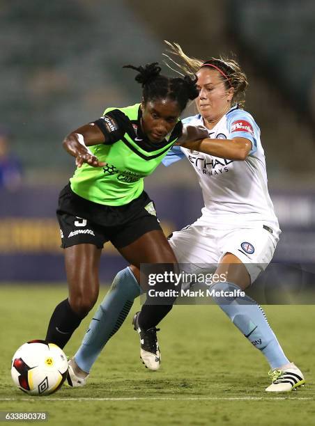 Jasmyne Spencer of Canberra is tackled by Lauren Barnes of Melbourne City during the W-League Semi Final match between Canberra United and Melbourne...