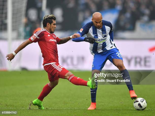 John Brooks of Berlin is challenged by Dario Lezcano of Ingolstadt during the Bundesliga match between Hertha BSC and FC Ingolstadt 04 at...