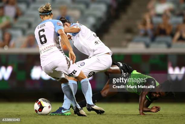 Jasmyne Spencer of Canberra is tackled by Aivi Luik of Melbourne City during the W-League Semi Final match between Canberra United and Melbourne City...