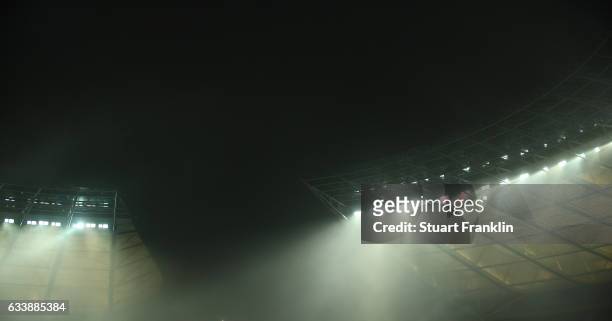 Floodlights shine through the mist during the Bundesliga match between Hertha BSC and FC Ingolstadt 04 at Olympiastadion on February 4, 2017 in...