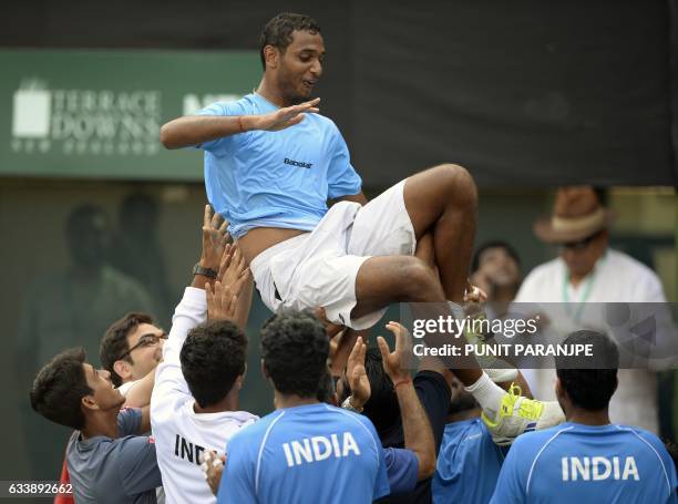 India's Ramkumar Ramanathan celebrates with team mates after winning the Davis Cup singles tennis match against New Zealand's Finn Tearney at the...