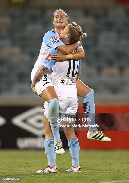 Jessica Fishlock and Lauren Barnes of Melbourne City celebrate victory at the end of the W-League Semi Final match between Canberra United and...