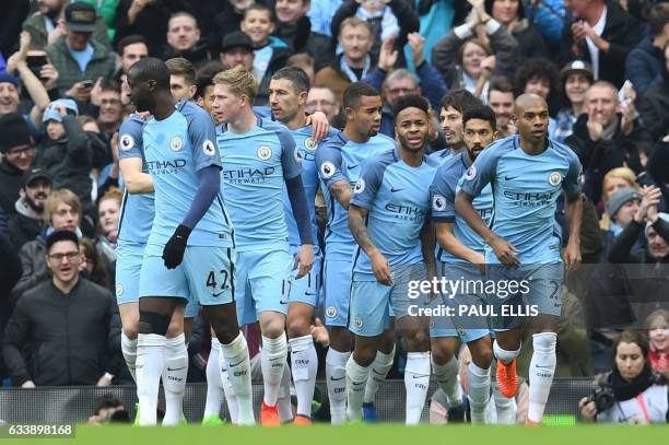 Manchester City's Brazilian striker Gabriel Jesus celebrates with teammates after scoring the opening goal of the English Premier League football...