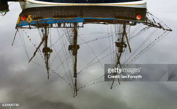 The masts from a replica version of the ship, Endeavour, used to provide trips for tourists is reflected in Whitby Harbour on February 5, 2017 in...