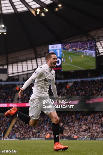 Swansea City's Icelandic midfielder Gylfi Sigurdsson celebrates after scoring their first goal during the English Premier League football match...