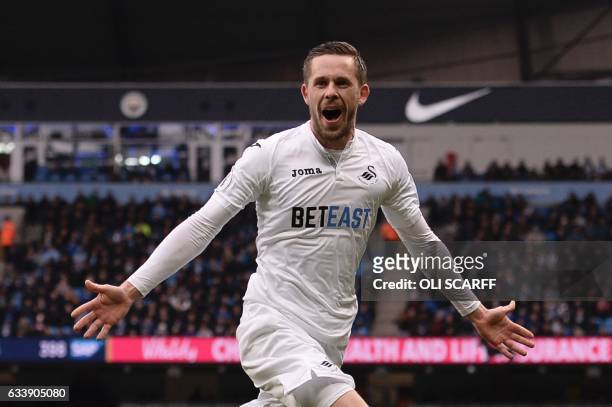 Swansea City's Icelandic midfielder Gylfi Sigurdsson celebrates after scoring their first goal during the English Premier League football match...