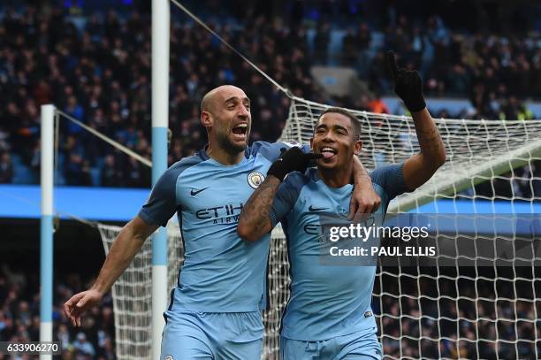 Manchester City's Brazilian striker Gabriel Jesus celebrates with Manchester City's Argentinian defender Pablo Zabaleta after scoring their late...