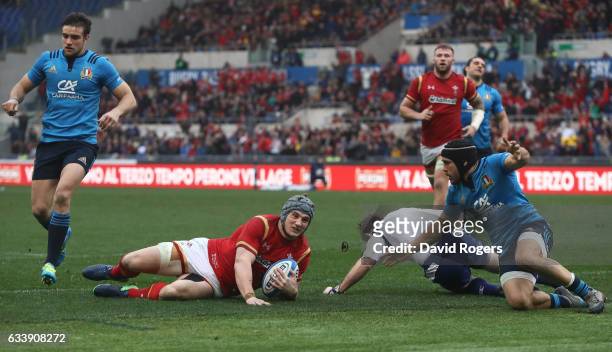 Jonathan Davies of Wales slides over to score his team's first try during the RBS Six Nations match between Italy and Wales at the Stadio Olimpico on...