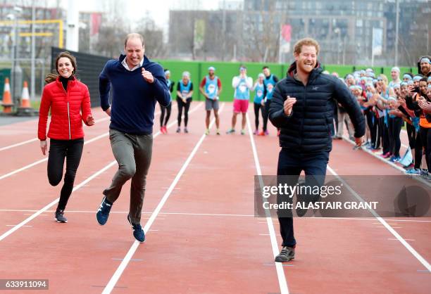 Britain's Catherine, Duchess of Cambridge , Britain's Prince William, Duke of Cambridge and Britain's Prince Harry take part in a relay race, during...