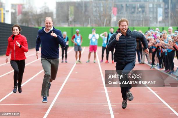 Britain's Catherine, Duchess of Cambridge , Britain's Prince William, Duke of Cambridge and Britain's Prince Harry take part in a relay race, during...