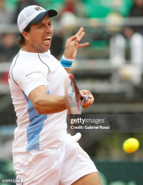 Carlos Berlocq of Argentina takes a forehand shot during a singles match between Carlos Berlocq and Paolo Lorenzi as part of day 3 of the Davis Cup...