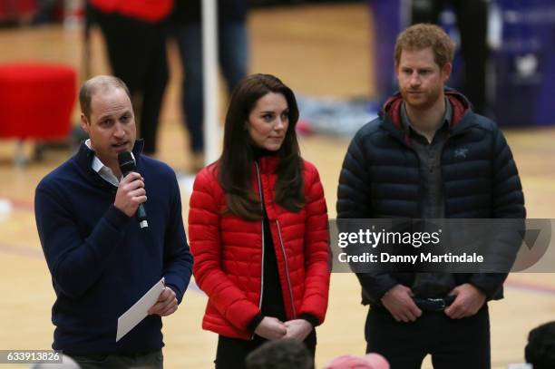 Prince William, Duke of Cambridge gives a speech as Catherine, Duchess of Cambridge and Prince Harry look on during a training day for the Heads...