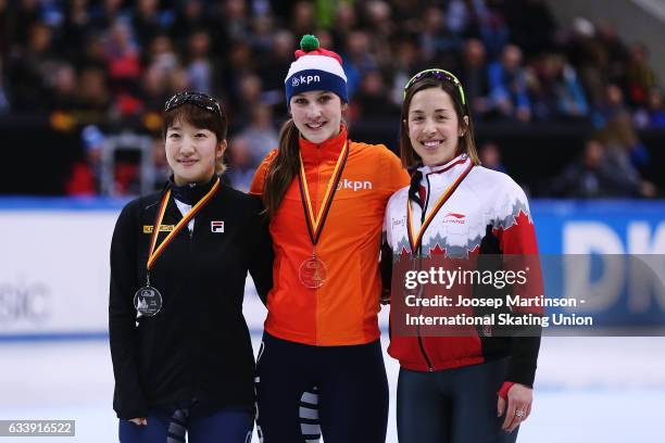 Ah Rum Noh of Korea, Suzanne Schulting of Netherlands and Valerie Maltais of Canada pose in the Ladies 1500m medal ceremony during day two of the ISU...