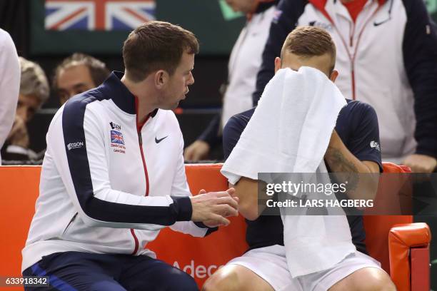 Great Britain's coach Leon Smith speaks with Daniel Evans during his match against Vasek Pospisil of Canada during the third day of Davis Cup first...