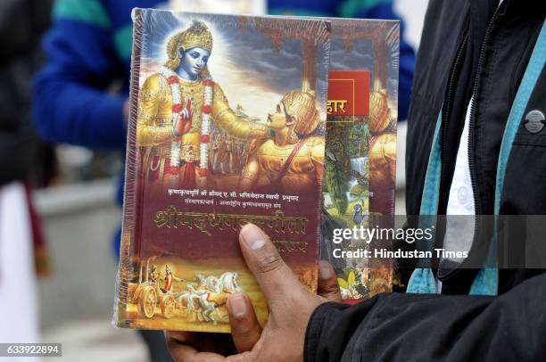 Hindu devotee selling a copy of Geeta during the Jagannath Rath Yatra Festival, on February 5, 2017 in Noida, India. Yatra is the name of the massive...